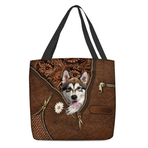 Alaskan Malamute Holding Daisy Tote Bag