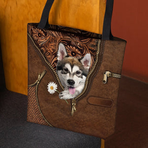 Alaskan Malamute Holding Daisy Tote Bag
