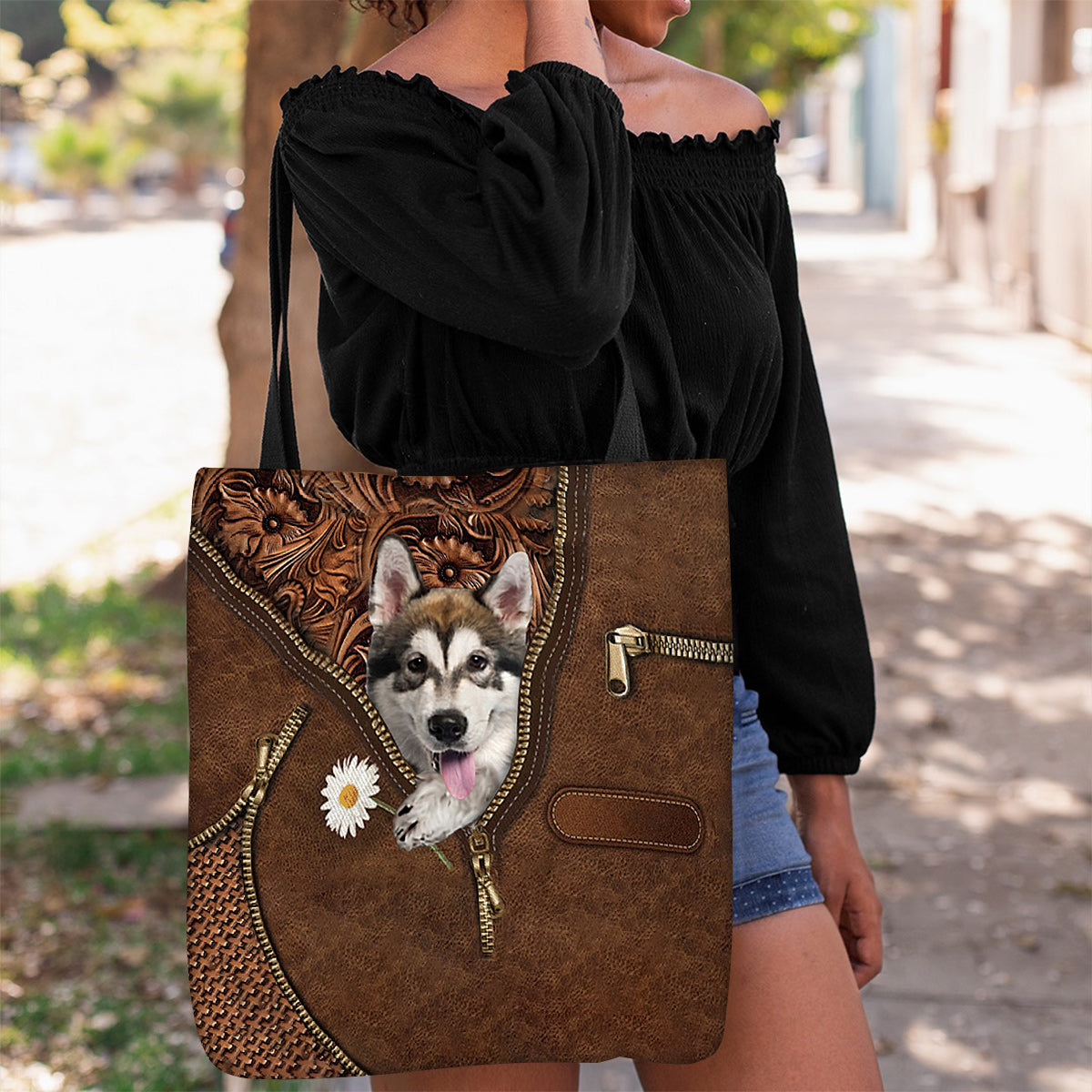 Alaskan Malamute Holding Daisy Tote Bag