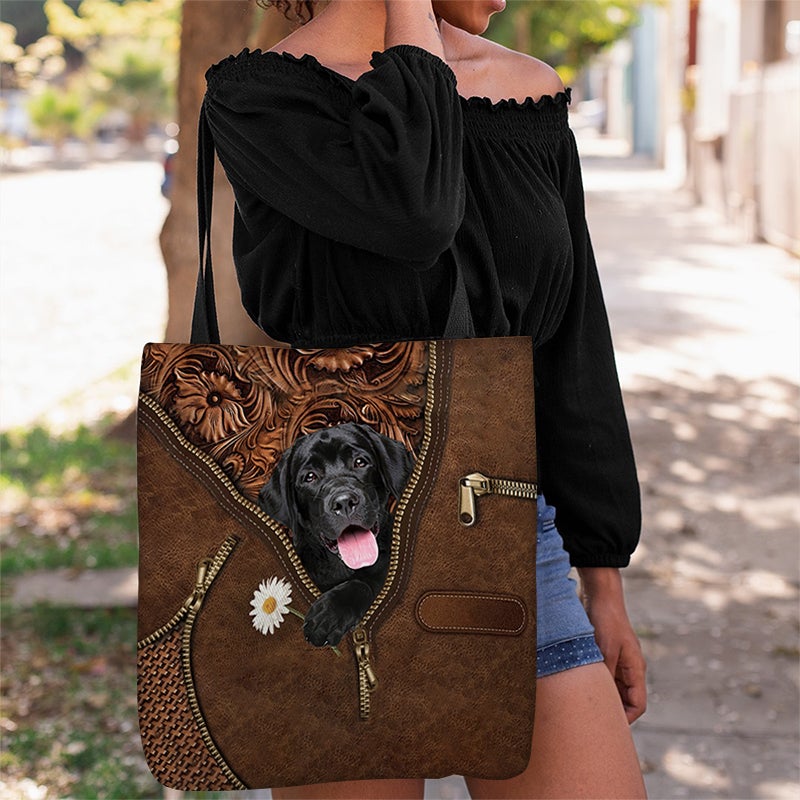 Black Labrador Retriever Holding Daisy Tote Bag
