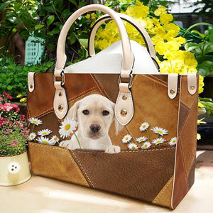Yellow Labrador Holding Daisy Leather Bag